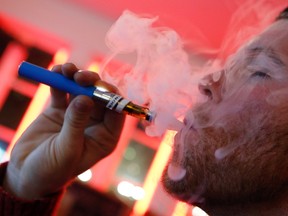 A customer puffs on an e-cigarette at the Henley Vaporium in New York City in this file photo taken Dec. 18, 2013.