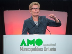 Ontario Premier Kathleen Wynne addresses delegates at the annual general meeting of the Association of Municipalities Ontario in London, Ont., on August 19, 2014. (DEREK RUTTAN/QMI Agency)