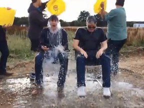 Tom Cruise and 'Mission: Impossible 5' director Chris McQuarrie get splashed. (YouTube)