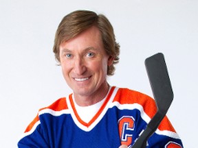 Hockey legend Wayne Gretzky holds a video game controller fashioned to look like a hockey stick. (Courtesy/EA Canada/File Photo)