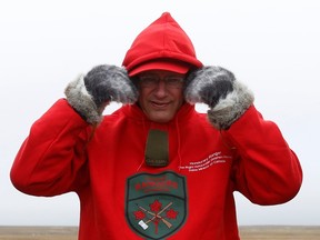 Canada's Prime Minister Stephen Harper adjusts his Canadian Rangers sweatshirt at a camp near the Arctic community of Gjoa Haven, Nunavut August 21, 2013. REUTERS/Chris Wattie