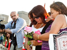 Valentina Fontaine attends a vigil in honour of her daughter, Tina Fontaine, as she is comforted. The vigil took place at the Alexander Docks in Winnipeg, Man., on Tues., Aug. 19, 2014. (Brook Jones/QMI Agency)