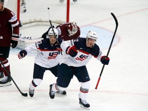 Johnny Gaudreau and Kevin Hayes (right) of the U.S. celebrate the goal of teammate Seth Jones against Latvia during the third period of their men's ice hockey World Championship Group B game at Minsk Arena in Minsk May 15, 2014. (REUTERS/Alexander Demianchuk)