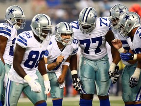 Tony Romo of the Dallas Cowboys talks in the huddle against the Baltimore Ravens in the first half of the preseason game at AT&T Stadium on August 16, 2014. (Ronald Martinez/Getty Images/AFP)