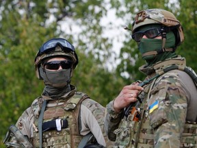 Ukrainian servicemen guard a checkpoint near the eastern Ukrainian town of Debaltseve, August 16, 2014. Ukrainian forces and pro-Russian separatists fought skirmishes near the Russian border on Saturday but there was no sign of the conflict widening after Kiev said it partially destroyed an armoured column that had crossed the border from Russia. REUTERS/Valentyn Ogirenko