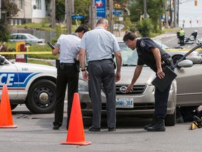 Police investigate a serious crash at Bank St. and Heron Rd., where a pedestrian suffered critical head injuries after being hit by a car Wednesday afternoon. (ERROL McGIHON Ottawa Sun)