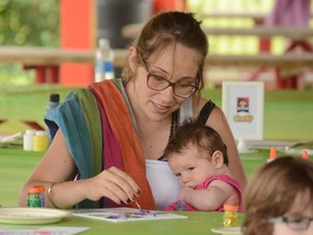 Joanna Stella creates a work of art at Momstown Belleville event art and play at Zwicks Park on Wednesday, August 20. - Zachary Shunock/for the Intelligencer.