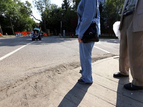 A couple cross the street on 95 ave and 92 st to their senior apartment building in Edmonton, Alberta on August 20, 2014. The crosswalk is considered a dangerous one.  Perry Mah/Edmonton Sun