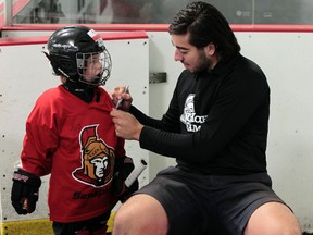 Senators’ Mika Zibanejad autographs a jersey at a kids camp at the Sensplex Wednesday. (Tony Caldwell/Ottawa Sun)