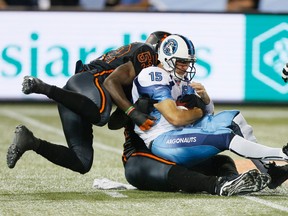 Argos QB Ricky Ray gets sacked as the B.C. Lions take an early lead in the first half against the Toronto Argonauts at the Rogers Centre  during CFL action in Toronto, Ont. on Sunday August 17, 2014. Stan Behal/Toronto Sun/QMI Agency