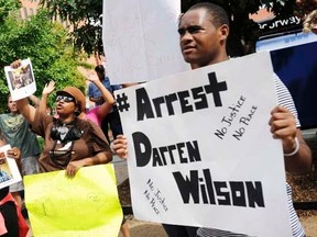 Protesters at the St. Louis County Justice Center call for the arrest of Police Officer Darren Wilson in Clayton, Missouri August 20, 2014.   REUTERS/Mark Kauzlarich