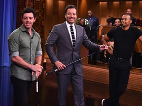 Golfers Rory Mcllroy (left) and Tiger Woods (right) visit The Tonight Show starring Jimmy Fallon earlier this week. (AFP)