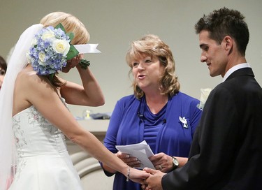 Megan Wolfe, 28, wipes away tears during her wedding to Josh Melynk, at the Union Bank Inn, 10053 Jasper Ave., in Edmonton Alta., on Wednesday Aug. 20, 2014. Wolfe has stage 4 stomach cancer. The couple turned to crowdfunding to make the wedding a reality. The couple has two year-old twin boys. Wolfe also has two other sons aged 6 and 7. Melynk also has an eleven year-old daughter. David Bloom/Edmonton Sun/QMI Agency