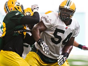 Offensive lineman Selvish Capers, right, takes part in drills during Edmonton Eskimos practice at the Commonwealth field house in Edmonton, Alta., on Wednesday, Aug. 20, 2014. Codie McLachlan/Edmonton Sun/QMI Agency