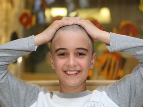 Eric Dupras, 11, has his head shaved by his mom, Lianne, in support of the Northeast Cancer Centre at the cancer centre in Sudbury, ON. on Wednesday, August 20, 2014. Eric decided to have his head shaved to support his great-uncle Gilles Laframboise, who has lung cancer. Eric and his family raised $650 for the Sam Bruno PET Scan Fund. JOHN LAPPA/THE SUDBURY STAR/QMI AGENCY