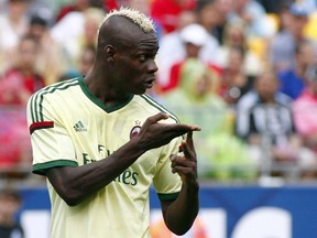 Mario Balotelli of AC Milan signals to teammates against Manchester City during International Champions Cup 2014 at Heinz Field on July 27, 2014 in Pittsburgh, Pennsylvania. (Justin K. Aller/Getty Images/AFP)