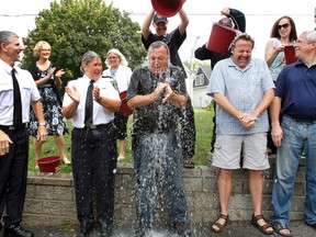 Belleville Police's Deputy Chief Paul Vandegraaf, left, Insp. Marlene Gray, second from left, city Councillors Egerton Boyce, second from right, and Jack Miller, right, watch as Mayor of Belleville Neil Ellis takes on the ALS Ice Bucket Challenge at Belleville Police Service station Thursday morning, Aug. 21, 2014. - Jerome Lessard/The Intelligencer/QMI Agency