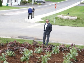 Coun. Garnet Thompson examines one of the landscaped areas added to the recently completed North Park Gardens project. Thompson along with several other members of council were present at the new entrance to West Riverside Park, Wednesday, for a ribbon-cutting event marking the completion of the $3 million initiative which includes the reconstruction of roads neighbouring the park.

Jason Miller/The Intelligencer