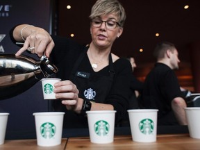 Sandy Roberts pours samples of Starbucks Reserve Sun Dried Ethiopia Yirgacheffe coffee during the company's annual shareholders meeting in Seattle, Washington in this file photo taken March 19, 2014. (REUTERS/David Ryder/Files)