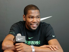 NBA basketball player Kevin Durant of the Oklahoma City Thunder smiles during a news conference in Taipei July 16, 2013. (REUTERS/Pichi Chuang)