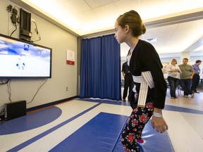 Bryanna Forest, 10, plays hockey during a demonstration of the Glenrose Hockey Nation rehabilitation video game at Glenrose Rehabilitation Hospital in Edmonton, Alta., on Thursday, Aug. 21, 2014. The game, which has been developed in Edmonton by 8-Bit 3D, received donations from the Telus Edmonton Community Board and Can-Am Geomatics. Ian Kucerak/Edmonton Sun