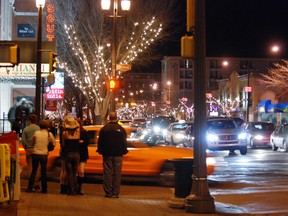 Pedestrians walk along Whyte Avenue at night. Photo Courtesy/City of Edmonton