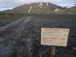 A warning sign blocks the road to Bardarbunga volcano, some 20 kilometres (12.5 miles) away, in the north-west region of the Vatnajokull glacier August 19, 2014. (REUTERS/Sigtryggur Johannsson)