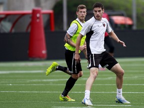 Ottawa Fury FC midfielder Nicki Paterson, left, fights for position with defender Drew Beckie while training at TD Place Thursday. Beckie sustained a serious injury in the Fury's game on Saturday, Aug. 23, 2014.
(Chris Hofley/Ottawa Sun)