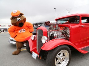 JOHN LAPPA/THE SUDBURY STAR/QMI AGENCYThe Great A&W; Root Bear checks out a 1931 Ford coupe at the Cruisin' to End MS event at the A&W; restaurant on Long Lake Road in Sudbury, ON. on Thursday, August 21, 2014. The event which raises money for the Multiple Sclerosis Society of Canada, featured a classic car show, games for kids, door prizes and entertainment. More than 800 A&W; restaurants across Canada donated $1 from every Teen Burger sold on Thursday to the MS Society.