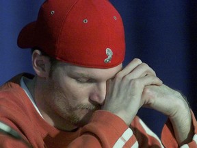 Dale Earnhardt, Jr. bows his head as other drivers of Dale Earnhardt Inc. thank fans for their support and said they are ready to return to racing regarding the upcoming race at North Carolina Raceway in Rockingham, North Carolina on February 23, 2001.  Earnhardt Sr. died on the final lap at the Daytona 500 on February 18, 2001.