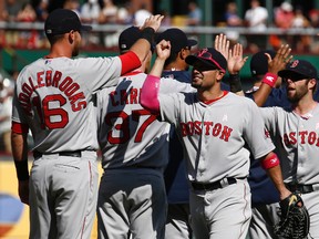 Boston Red Sox right fielder Shane Victorino is congratulated by third baseman Will Middlebrooks following their teams win over the Texas Rangers 5-2 at Globe Life Park on May 11, 2014. (Jim Cowsert/USA TODAY Sports)