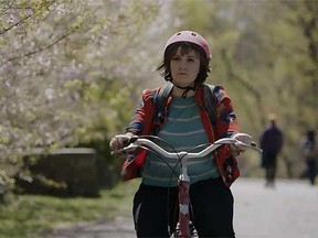 Lena Dunham's Hannah rides a bike down a shady, beautiful path in the trailer for season four of "Girls". (Screen grab)