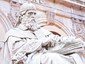 An 1892 statue of St. Isidore of Seville by Jose Alcoverro stands outside the Biblioteca Nacional de Espa?a, in Madrid. bob Ripley considers the possibility of him ? or another ? becoming patron saint of the Internet. (Renata Sedmakova/Fotolia)