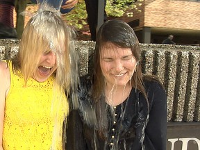 Free Press interns Jennifer Bieman, left, and Megan Stacey take the ALS ice-bucket challenge on Friday.