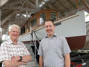 Ron Lees, left, chairman of the Friends of the Phoebe, and Gordon Robinson, curator of the Pump House Steam Museum, stand in front of the Phoebe in this 2014 file photo. (Michael Lea/Whig-Standard file photo)