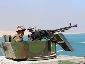 Peshmerga fighter is seen in a vehicle as he guards Mosul Dam in northern Iraq August 21, 2014. Iraqi and Kurdish forces recaptured Iraq's biggest dam from Islamist militants with the help of U.S. air strikes to secure a vital strategic objective in fighting that threatens to break up the country, Kurdish and U.S. officials said on Monday.  REUTERS/Youssef Boudlal