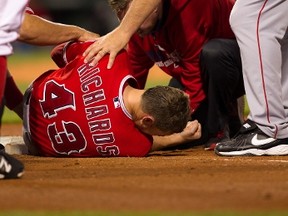 Garret Richards is tended to on the Fenway Park turf after injuring his knee covering first base earlier this week. (AFP)