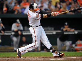 Baltimore Orioles third baseman Manny Machado (13) doubles in the first inning against the New York Yankees at Oriole Park at Camden Yards. (Joy R. Absalon-USA TODAY Sports)