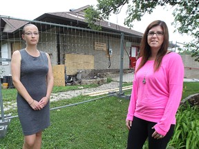 Adria Mielke (right), the vice-president of the Windsor Community Club, and Debbie Bell, the treasurer of Windsor Cares for Kids, which leased space in the club's basement, stand outside the club on Sat., Aug. 23, 2014. Heavily damaged by fire on Aug. 6, the Elm Park club is expected to remain closed for at least six months. Kevin King/Winnipeg Sun/QMI Agency