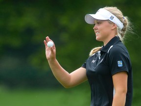 Brooke Henderson waves to the crowd after sinking a putt on the fourth green during Round 3 of the 2014 Canadian Pacific Canadian Women's Open at the London Hunt and Country Club in London, Ontario on Saturday August 23, 2014.
CRAIG GLOVER/The London Free Press/QMI Agency