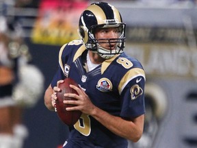 St. Louis Rams quarterback Sam Bradford looks for a pass during the first half of their NFL football game against the Minnesota Vikings in St. Louis, Missouri, December 16, 2012. REUTERS/Sarah Conard