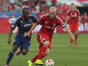 Toronto FC. Micheal Bradley fights off Chicago Fire Sanna Nyassi at the BMO Field in Toronto, Ont. on Saturday August 23, 2014. (Dave Thomas/Toronto Sun/QMI Agency)