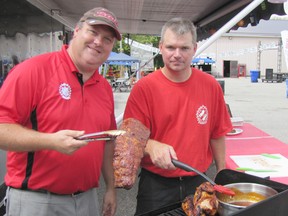 Dustin Pumfrey, left, and Darren Wills of the Dresden Kinsmen Club were among the cooks at the Wallaceburg Kinsmen Ribfest who helped out at the third-annual event. Don Robinet/QMI Agency