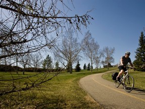 A man rides his bicycle at Rundle Park in Edmonton, Alta., on Monday, May 6, 2013. Ian Kucerak/Edmonton Sun/QMI Agency