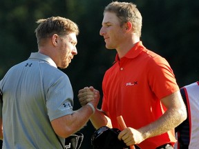Hunter Mahan shakes hands with Morgan Hoffmann after they finished on the 18th green during the final round of The Barclays at The Ridgewood Country Club on August 24, 2014 in Paramus, New Jersey.  (Hunter Martin/Getty Images/AFP)