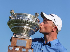 David Bradshaw kisses the trophy as the winner of the PGA Tour Canada's Great Waterway Classic on Sunday at  Loyalist Golf Club. (Julia McKay/The Whig-Standard)