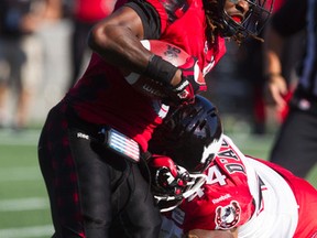 Ottawa Redblacks hosted the Calgary Stampeders at TD Place for a regular season match-up, August, 24, 2014.  Redblacks, Jamill Smith (left) breaks a tackle attempt by Stampeders defensive lineman Ben D'Aguilar (right).    
(Chris Roussakis/Ottawa Sun)