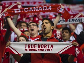 Canadian fans sing the national anthem before the CONCACAF Women's Olympic qualifying soccer match.

REUTERS/Andy Clark