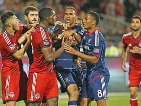 TFC’s Doneil Henry shoves Grant Ward of the Chicago Fire during their game on Saturday night at BMO Field. Henry came on for an injured Steven Caldwell and acquitted himself well, according to head coach Ryan Nelsen. The teams drew 2-2. (USA Today Sports)