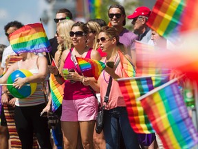 Revellers take part in the Ottawa Pride Parade on Bank Street, August, 24, 2014. Over 75,000 people were said to take part in the days festivities.     (Chris Roussakis/Ottawa Sun)